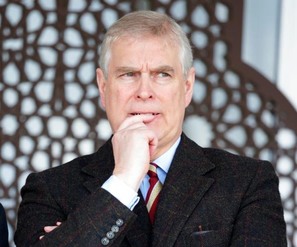 Prince Andrew, Duke of York, in a suit, with his hand on his chin at the Royal Windsor Horse Show, Windsor, England.