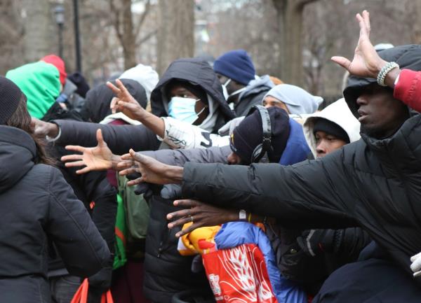 Migrants during a winter clothing handout in Tompkins Square Park on Mo<em></em>nday as temperatures sank to the thirties