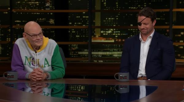 Bill Maher and James Carville sitting at a table havin<em></em>g a discussion on Real Time with Bill Maher