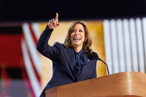 VP Kamala Harris delivering her acceptance speech at the DNC Co<em></em>nvention in Chicago, pointing her finger while standing at a podium with a microphone
