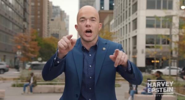 John Mulaney as Harvey Epstein in an SNL skit, pointing at the camera during a city council election campaign commercial.