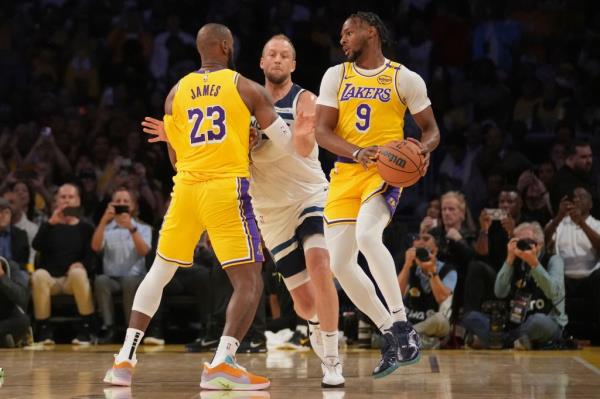 Los Angeles Lakers guard Bro<em></em>nny James handling the basketball during a game against the Minnesota Timberwolves as LeBron James sets a screen