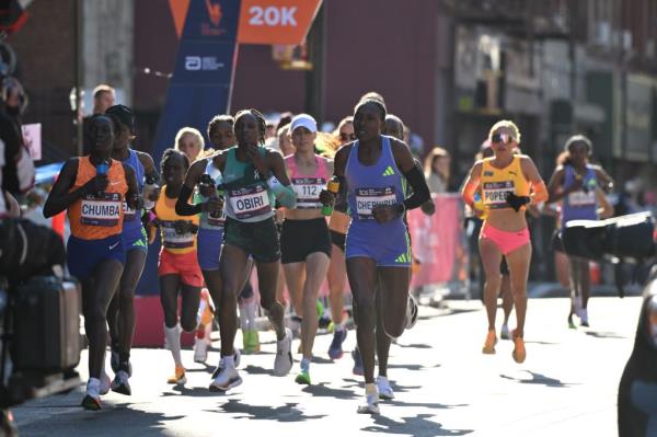Elite women runners Eunice Chumba, Hellen Obiri, and Sheila Chepkirui crossing the 20K mark at the 53rd annual New York City Marathon