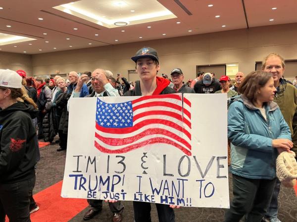 A young Do<em></em>nald Trump backer holds up a sign in support of the former president during a recent rally in Green Bay on April 2, 2024.