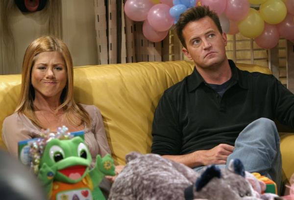 Aniston makes a funny face as she sits with Perry in between takes on the set of 