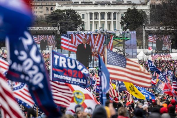 Do<em></em>nald Trump is seen on a screen as his supporters cheer during a rally on the Natio<em></em>nal Mall on January 6, 2021 in Washington, DC.