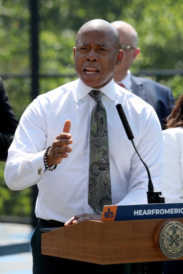 New York City Mayor Eric Adams speaking at a podium during a press co<em></em>nference announcing an education budget investment at PS 184 M Shuang Wen School.