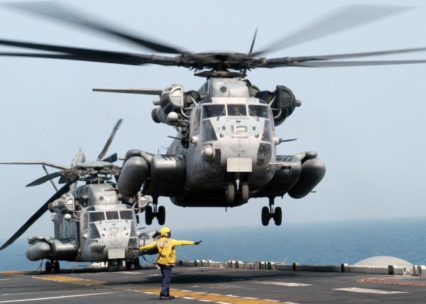 a US Marine Corps CH-53E 'Super Stallion' helicopter preparing for a mission on an amphibious assault ship, provided by the US Navy