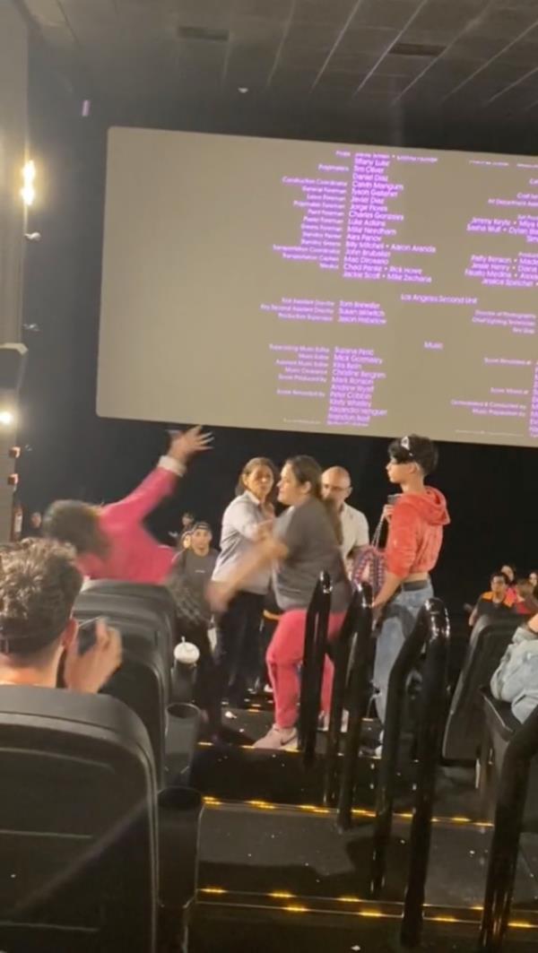 Spring up to retaliate, the woman then attacks the other lady with a shoe until two men manage to separate the two women and one is escorted away. 