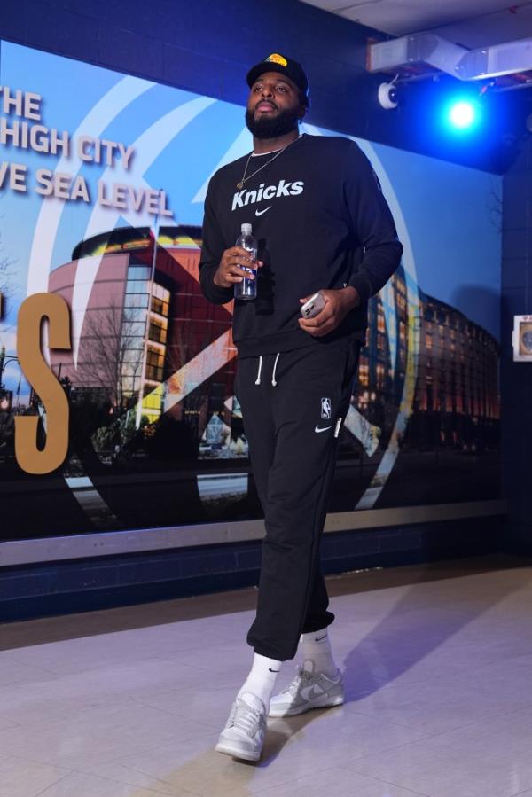 Mitchell Robinson #23 of the New York Knicks arrives to the arena before the game against the Denver Nuggets on November 25, 2024.