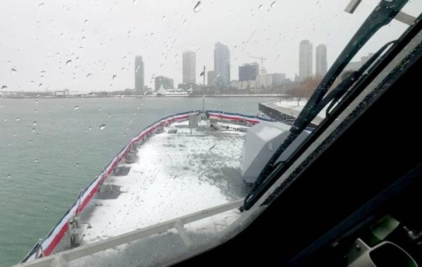 View of the Milwaukee skyline from the snow-covered deck of the future USS Beloit (LCS 29) on Nov. 21, 2024.