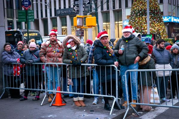 Tourists wearing festive outfits lined up hours before the tree lighting.