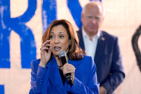 Democratic presidential nominee Vice President Kamala Harris speaks as Democratic vice presidential nominee Minnesota Gov. Tim Walz listens at a campaign event, Sunday, Aug. 18, 2024, in Rochester, Pa.