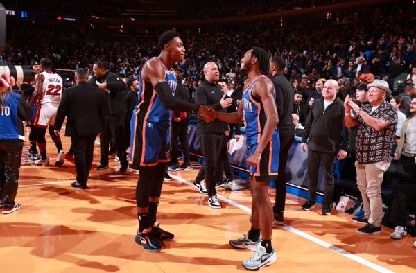 RJ Barrett #9 and Immanuel Quickley #5 of the New York Knicks celebrate after the game against the Miami Heat during the In-Season Tournament.