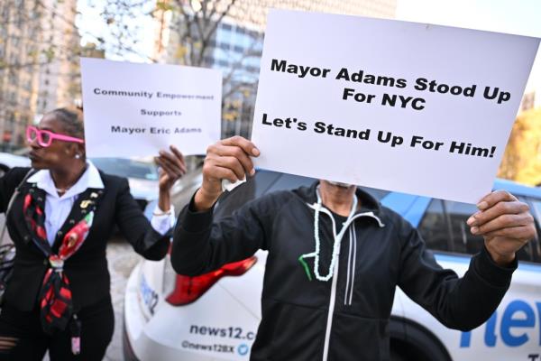 pro-Adams demo<em></em>nstrator holding sign