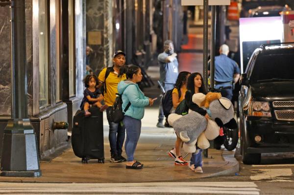 Migrants are seen leaving the Roosevelt Hotel at 45 Street and Madison Avenue. 