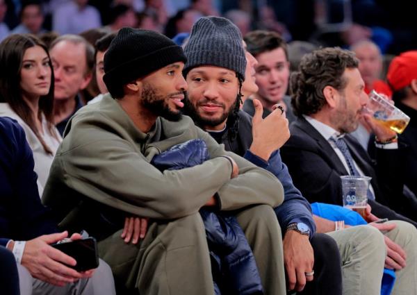 Nets forward Mikal Bridges #1 and New York Knicks guard Jalen Brunson #11 sit court side together
