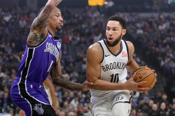 Ben Simmons (10) is guarded by Sacramento Kings forward DeMar DeRozan, left, during the first half of an NBA basketball game in Sacramento, Calif., Sunday, Nov. 24, 2024. 