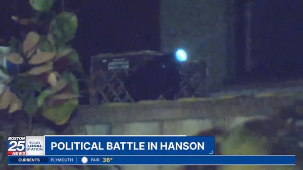 Projection of 'Trump 2024' on a white water tower at night from a nearby private property