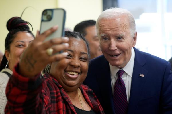 President Joe Biden takes a photo as he visits CJ's Cafe in Los Angeles, Wednesday, Feb. 21, 2024. 