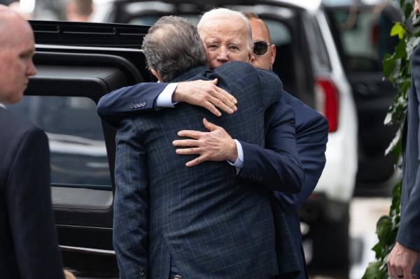 President Joe Biden hugs his son Hunter Biden as they leave The Ivy restaurant in Los Angeles, California, February 4, 2024.