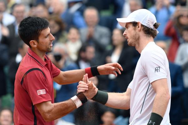 Serbia's Novak Djokovic (L) shakes hands with Britain's Andy Murray after winning the men's final match at the Roland Garros 2016 French Tennis Open