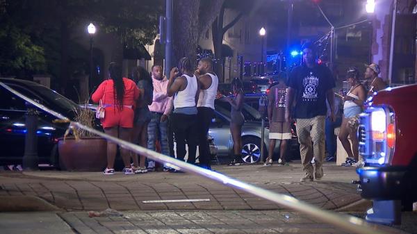 Bystanders near the scene of a shooting in Birmingham, Ala., Sunday, Sept. 22, 2024