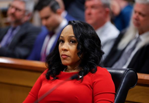 Fulton County District Attorney Fani Willis listens during the final arguments in her disqualification hearing at the Fulton County Courthouse on March 1, 2024
