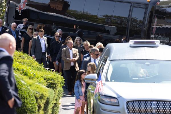 A bus full of mourners arriving at the church.