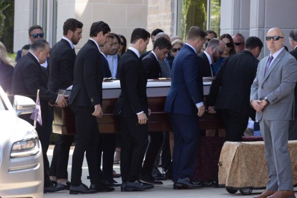The two caskets being carried by pallbearers into the church at the beginning of the mass.