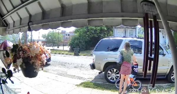 The woman -- identified by cops as Nacrelli -- looks over her shoulder toward the house before bending back over the boy while “talking to him and rubbing him,