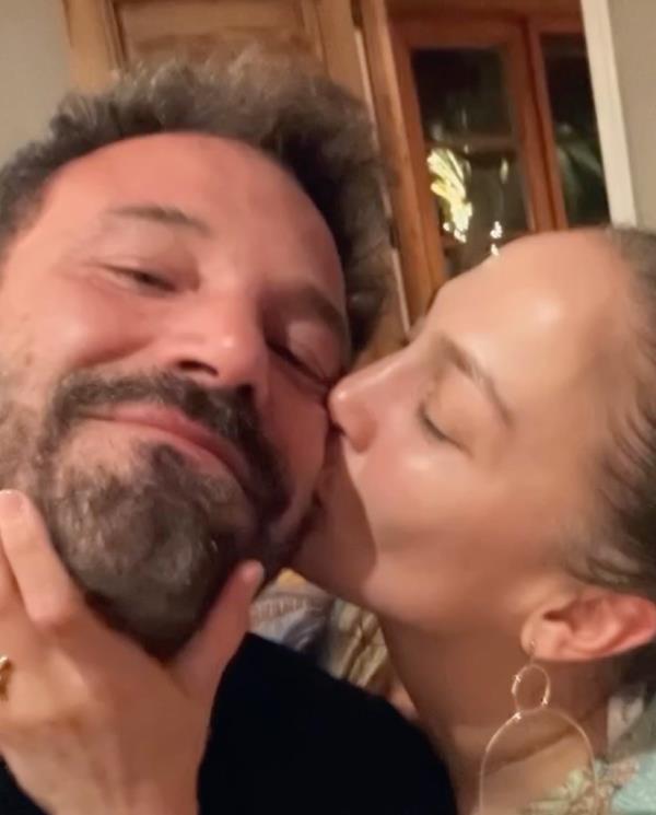Jennifer Lopez kisses husband Ben Affleck's cheek in a photo posted on Lopez's Instagram.