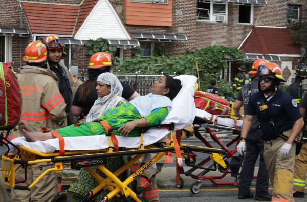 An injured person being taken away on a stretcher.