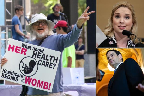 A doctor uses a hand-held Doppler probe on a pregnant woman to measure the heartbeat of the fetus