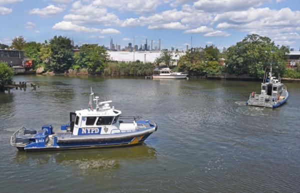 An NYPD boat trolls Newtown Creek