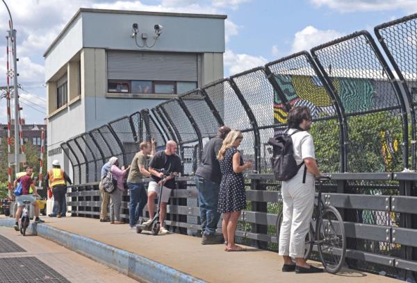 People watch as the NYPD searches Newtown Creek