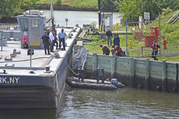 Authorities search Newtown Creek.