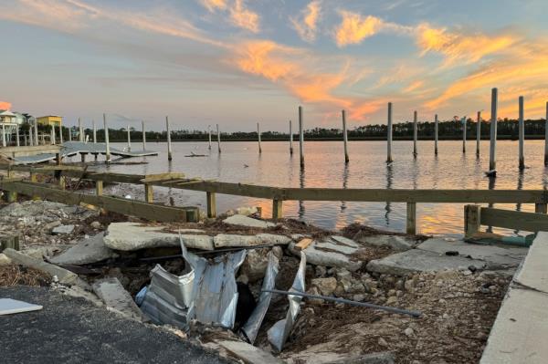 Sunset over the storm-damaged Steinhatchee marina with a broken bridge, in the aftermath of Hurricane Helen