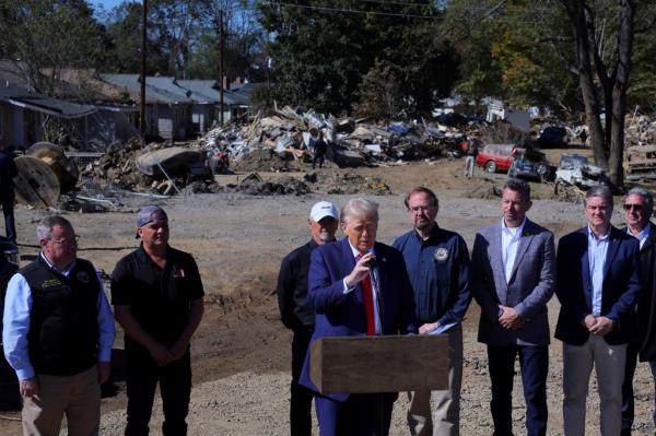 Former U.S. President Do<em></em>nald Trump addressing a group of people at a hurricane-damaged site in Swannanoa, North Carolina.