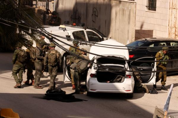 Israeli security forces check a car that was reportedly used by a Palestinian to carry out a thwarted ramming attack against troops positio<em></em>ned near the settlement of Kiryat Arba.