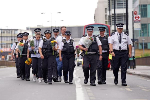 Police officers arrive to lay flowers at the scene in Croydon, south London, wher<em></em>e 15-year-old Elianne Andam was stabbed