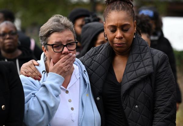 Members of the pubic pay tribute to murdered 15-year-old Elianne Andam, at the police cordon at the scene of her murder at a bus stop, outside the Whitgift Centre on Wellesley Road in Croydon