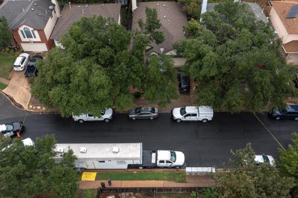 Police vehicles are pictured in the residential neighborhood.
