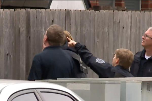 Police are pictured combing through the scene of the fatal shooting.