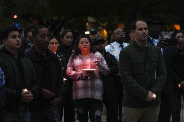 a<em></em>bout one hundred police officers and Austin residents gather for a rally for the Austin Police Department and candlelight vigil for officer Jorge Pastore.