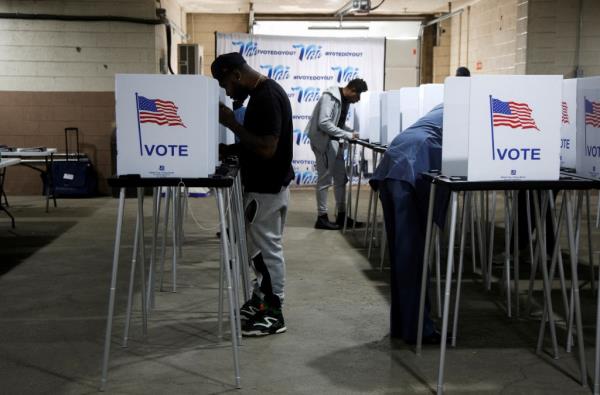Voters filling out their ballots during early voting for the presidential election at the Detroit Elections Office in Michigan, U.S., October 28, 2024