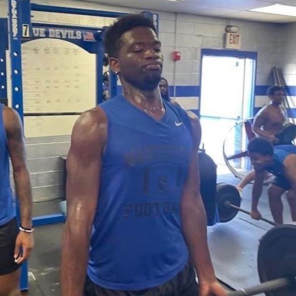 Smith is pictured lifting weights.