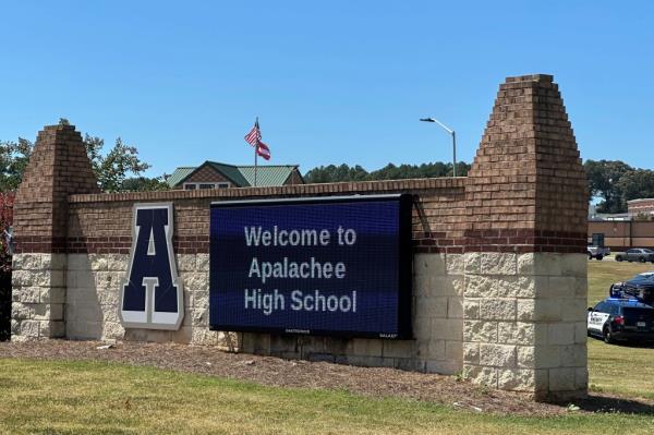 Law enforcement arriving at Apalachee High School in Winder, GA, with students being evacuated to the football stadium during a lockdown