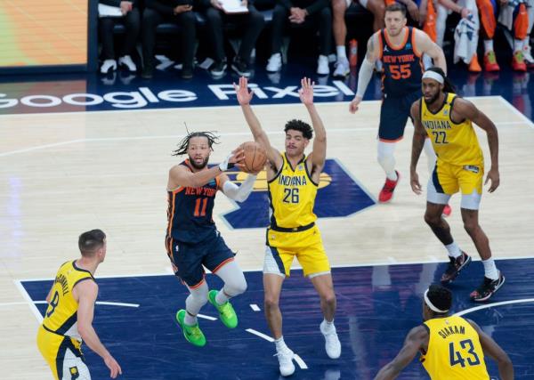Knicks guard Jalen Brunson (11) makes a jumping pass during Sunday's Game 4 loss.