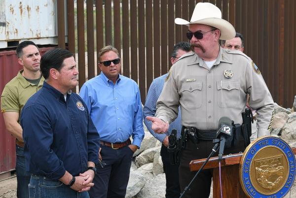 Yuma County Sheriff Leon Wilmot, right, thanks Arizona Gov. Doug Ducey, second from left, for his support and bringing in shipping co<em></em>ntainers to fill gaps in the border wall during a media event Thursday, Sept. 8, 2022 in Yuma, Arizona